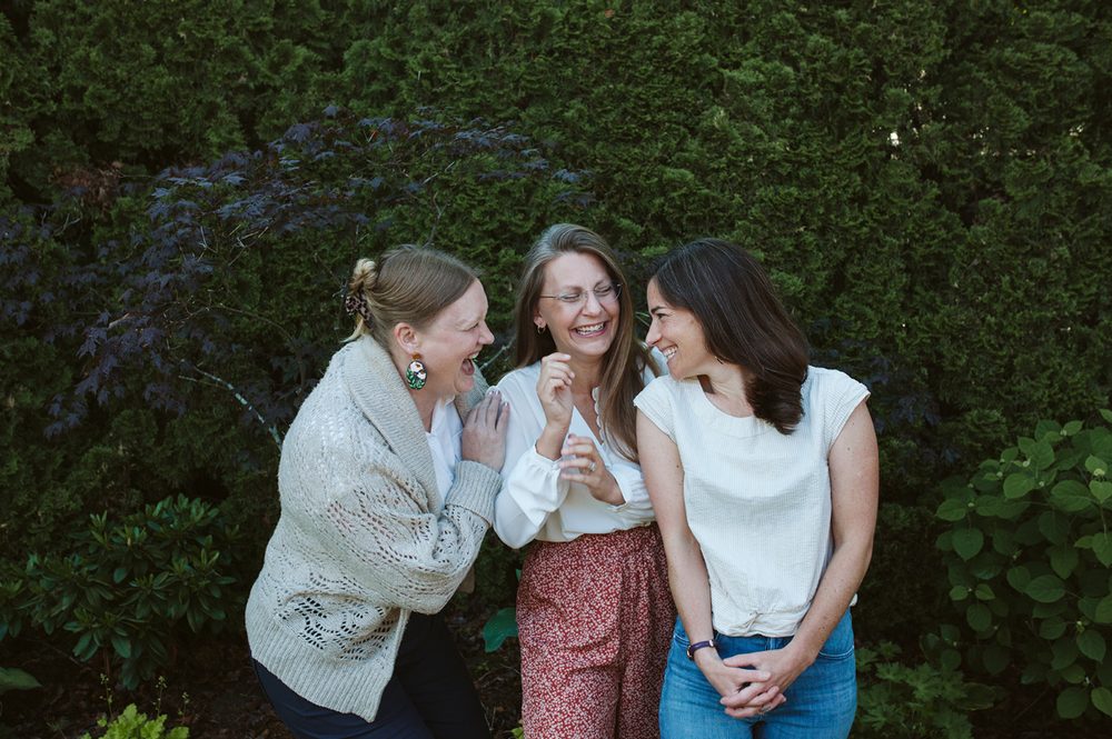Three members of the team laughing together
